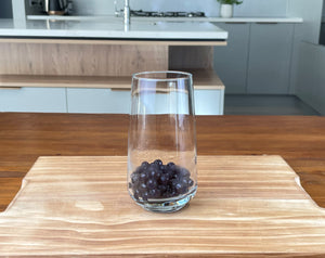 Glass holding cooked dark purple Blueberry tapioca fruit pearls