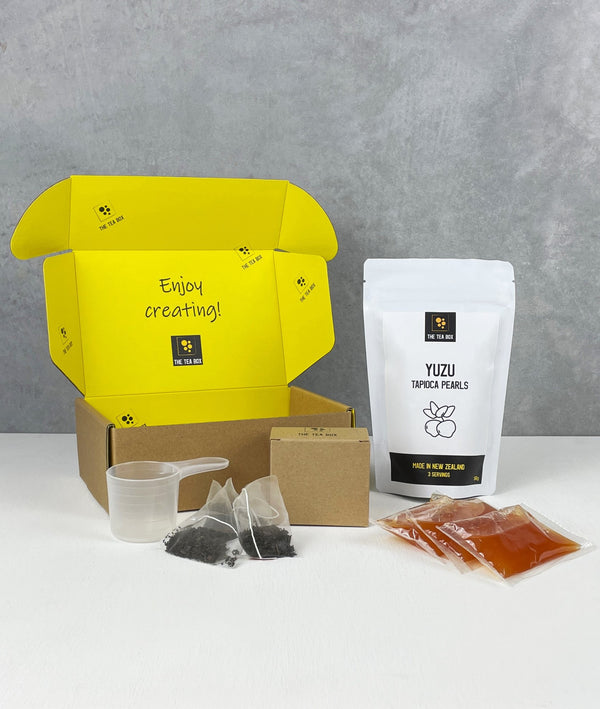 Contents of 3 pack Peach Bubble Tea Kit. Yuzu pearls in pouch, sachets of fruit mix, tea bags, scoop and cardboard gift box