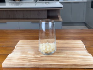 Glass holding cooked red grapefruit tapioca fruit pearls