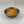 Load image into Gallery viewer, Small black ceramic dish filled with orange-coloured Passionfruit fruit mix