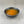 Load image into Gallery viewer, Small black ceramic dish filled with orange-coloured Passionfruit fruit mix