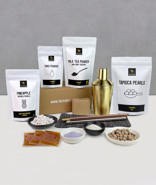 Contents of 9 pack Starter Kit with Cocktail Shaker. Pouch of 3 serve Taro Powder, 3 serves Pineapple Tapioca Pearls, 3 serves Milk Tea Powder, 6 serves Brown Tapioca Pearls, 3 sachets Lychee & Passionfruit fruit mix, 3 Stainless Steel Bubble Tea Straws, 6 English Breakfast Tea Bags, stainless steel Cocktail Shaker in brushed gold