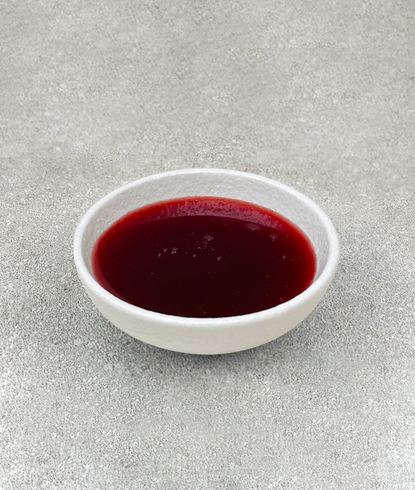 Small white ceramic dish filled with red Strawberry fruit mix