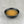 Load image into Gallery viewer, Small black ceramic dish filled with light orangey yellow Lychee fruit mix
