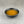 Load image into Gallery viewer, Small black ceramic dish filled with light orange Lychee and Passionfruit fruit mix
