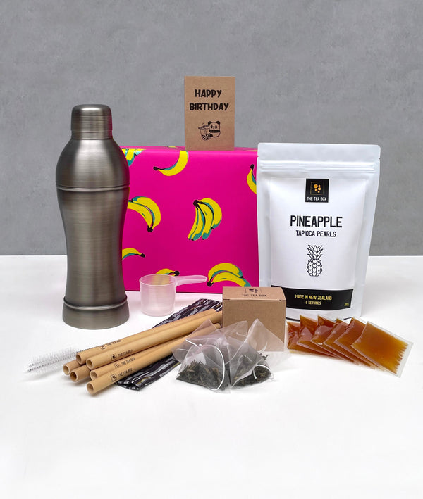 6 pack Passionfruit Bubble Tea gift pack. Pineapple pearls, sachets of Passionfruit fruit mix, tea bags, 6 bamboo straws, antique grey stainless steel cocktail shaker, greeting card, gift box wrapped in pink banana wrapping paper