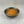 Load image into Gallery viewer, Small black ceramic dish filled with orange-coloured Passionfruit fruit mix
