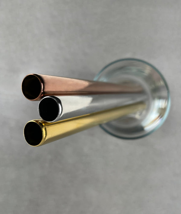 Close-up of the ends of 3 stainless steel bubble tea straws. Shows the ends have a smooth, rounded edge