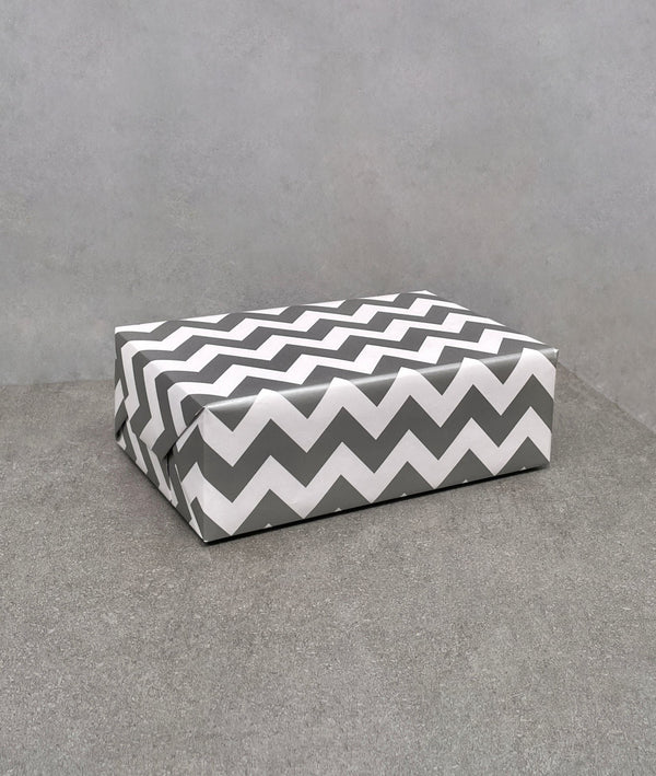 Chevron gift wrap. Grey and white zig-zag pattern on gloss paper