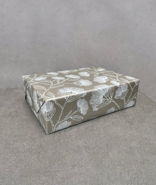 Pohutukawa gift wrapping paper. Silvery brown background covered in white pohutukawas