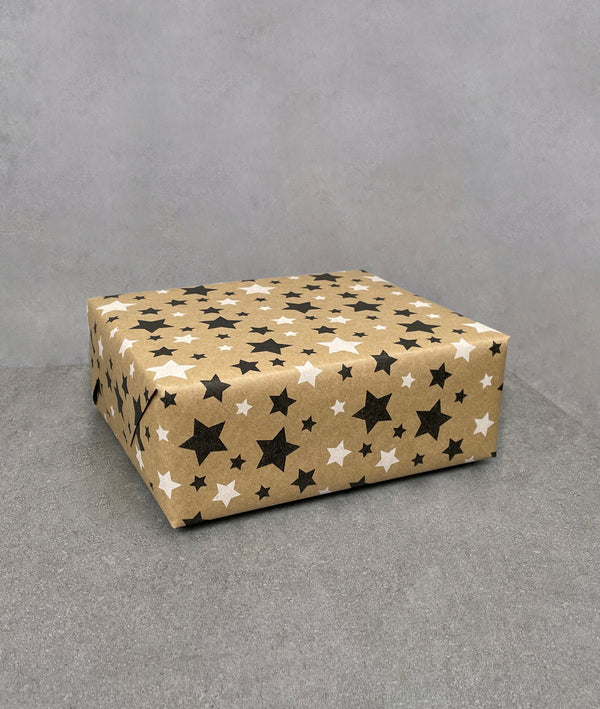 Stars gift wrapping paper. Brown kraft paper covered in black and white stars
